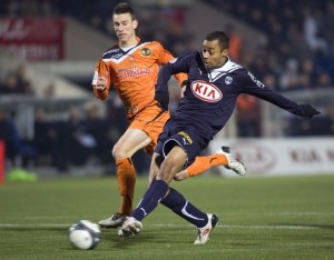 Girondins Bordeaux's Bellion scores in front of Koscielny of FC Loriens during their  French Ligue 1 match in Bordeaux